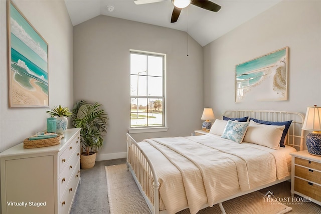 carpeted bedroom with ceiling fan and vaulted ceiling