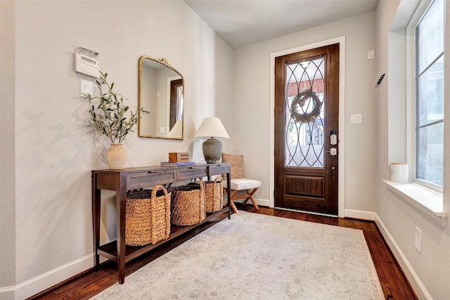 entryway with dark hardwood / wood-style flooring