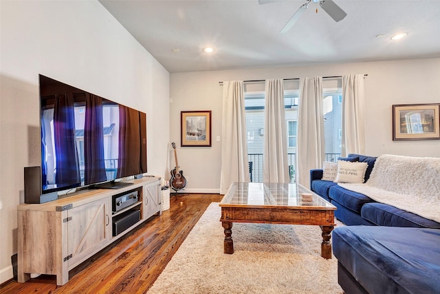 living room with dark hardwood / wood-style floors and ceiling fan