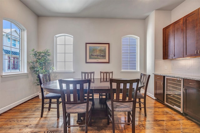 dining room featuring wood-type flooring and beverage cooler