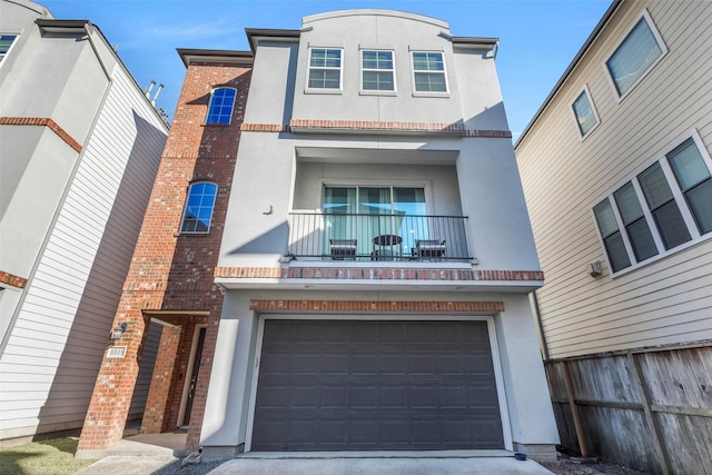 view of property with a garage and a balcony