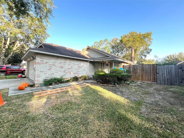 view of property exterior featuring a lawn and a garage