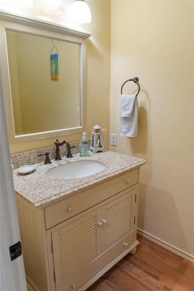 bathroom with hardwood / wood-style floors and vanity