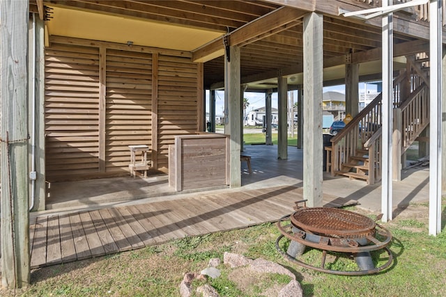 view of patio featuring a fire pit and a wooden deck