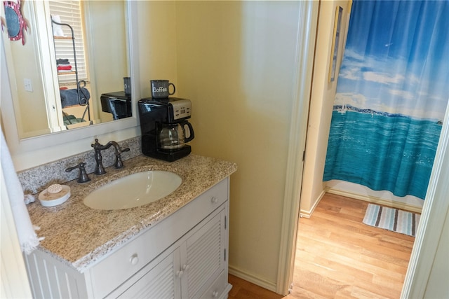 bathroom featuring wood-type flooring and vanity