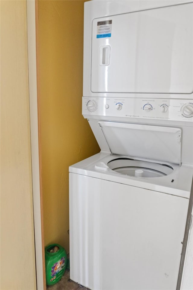 laundry area featuring stacked washer / dryer