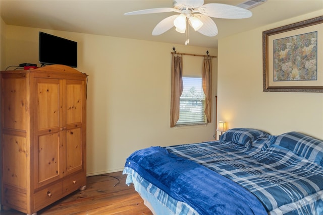 bedroom featuring hardwood / wood-style floors and ceiling fan