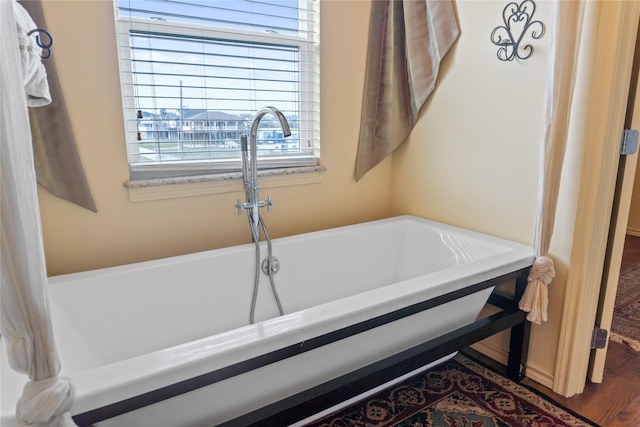 bathroom featuring a bathtub and hardwood / wood-style flooring