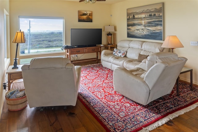 living room with dark hardwood / wood-style floors and ceiling fan