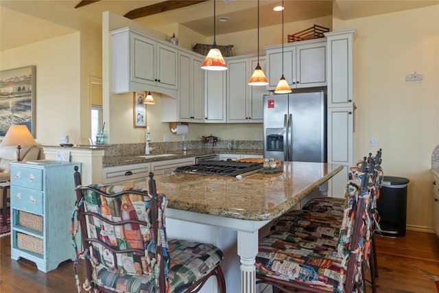 kitchen featuring dark hardwood / wood-style floors, stainless steel fridge with ice dispenser, sink, and decorative light fixtures