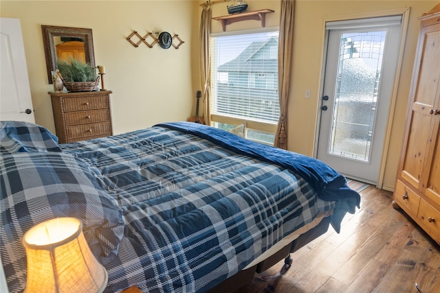 bedroom with multiple windows and hardwood / wood-style floors