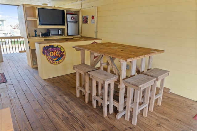 dining area featuring wooden walls and light hardwood / wood-style floors