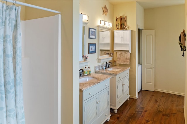 bathroom featuring wood-type flooring, vanity, and a shower with curtain