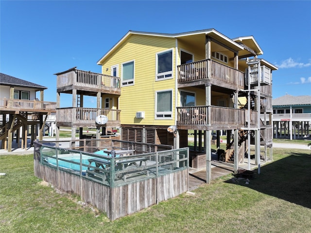 back of house with a lawn and a covered pool