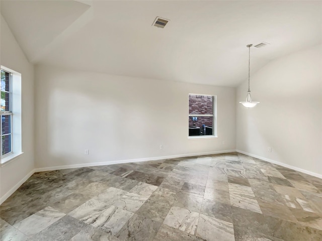 unfurnished room featuring a healthy amount of sunlight and lofted ceiling