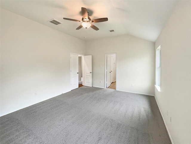 spare room featuring carpet, ceiling fan, and lofted ceiling