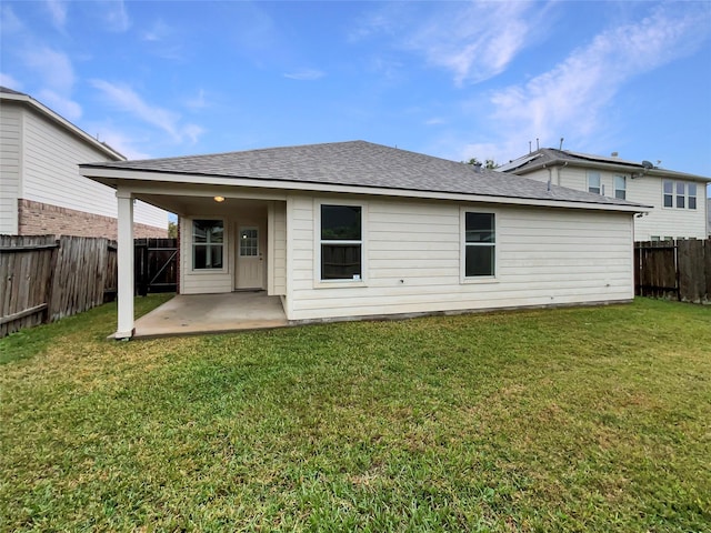 rear view of house with a patio area and a yard