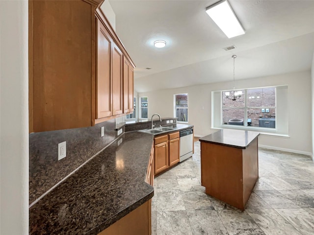 kitchen featuring dishwasher, an inviting chandelier, sink, hanging light fixtures, and kitchen peninsula