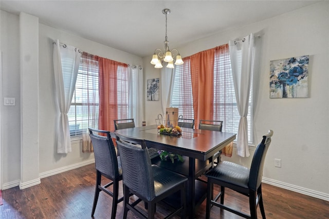 dining room with dark wood-type flooring and a notable chandelier