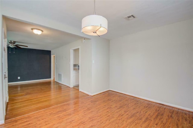 empty room with ceiling fan and wood-type flooring