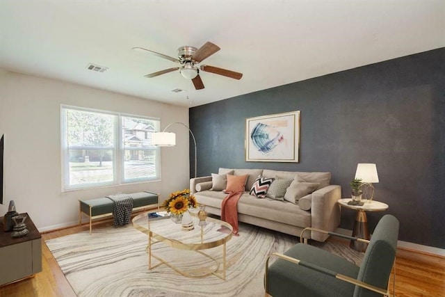 living room featuring ceiling fan and wood-type flooring