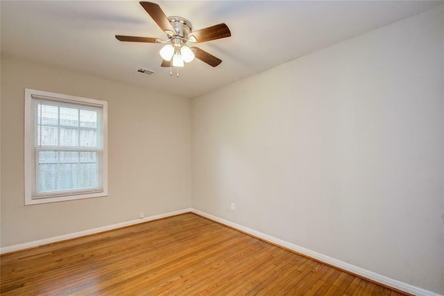 spare room with ceiling fan and light wood-type flooring