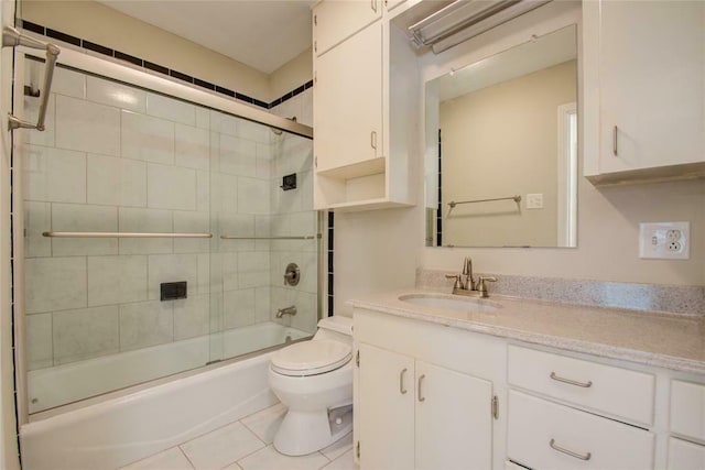 full bathroom featuring tile patterned floors, vanity, enclosed tub / shower combo, and toilet