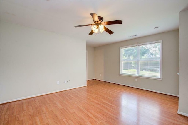 spare room with light wood-type flooring and ceiling fan