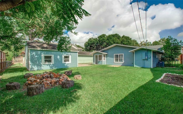 back of house with a yard and central AC unit