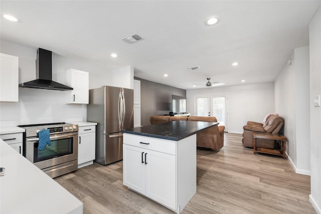 kitchen with white cabinetry, wall chimney exhaust hood, and appliances with stainless steel finishes