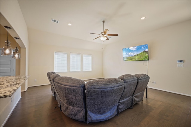 living room with ceiling fan and dark hardwood / wood-style flooring