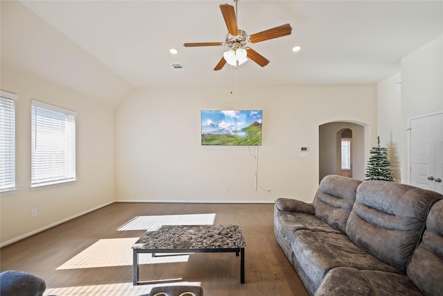 living room with ceiling fan, hardwood / wood-style floors, and vaulted ceiling