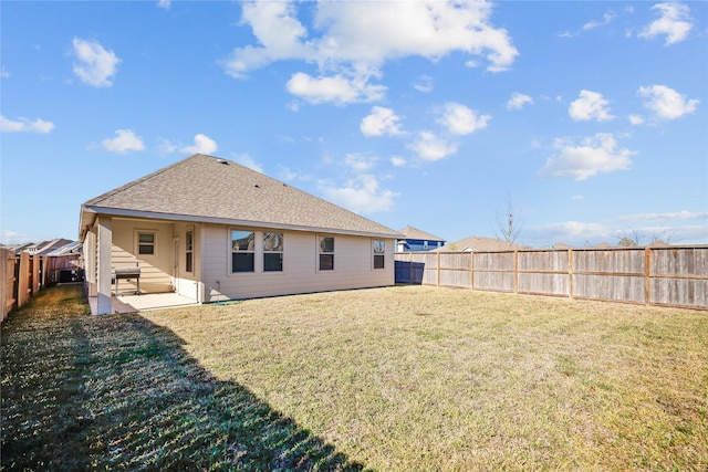 back of property featuring a yard and a patio