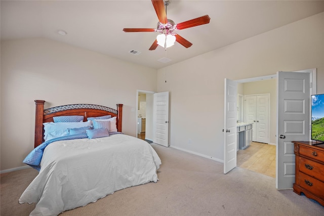 bedroom with light carpet, ensuite bath, ceiling fan, and lofted ceiling