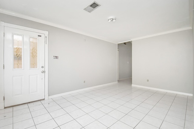 empty room featuring crown molding and light tile patterned floors