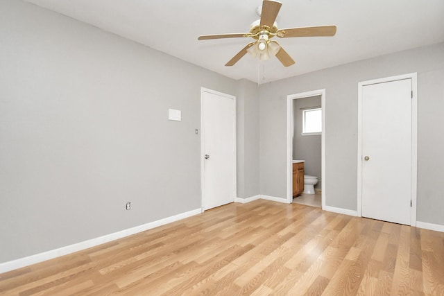 unfurnished bedroom featuring ensuite bath, ceiling fan, and light hardwood / wood-style flooring