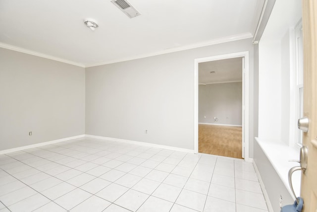 tiled empty room featuring ornamental molding