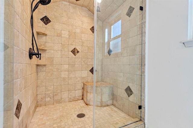 bathroom with a shower with door