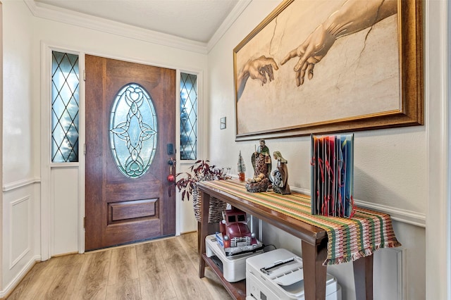 entryway featuring light hardwood / wood-style floors and ornamental molding