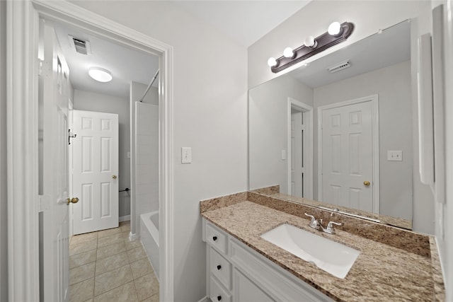 bathroom with tile patterned floors, vanity, and bathing tub / shower combination