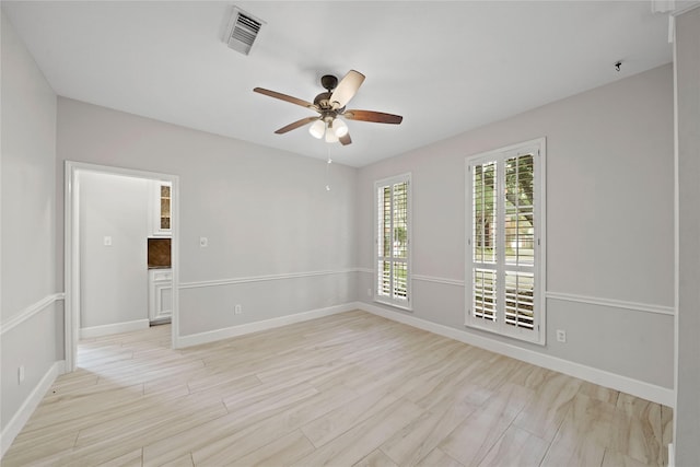 unfurnished room featuring ceiling fan and light wood-type flooring