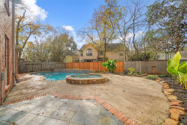 view of swimming pool featuring a patio area and an in ground hot tub