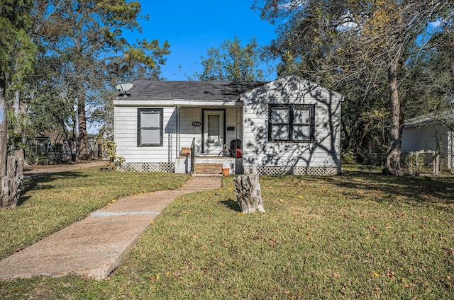 bungalow-style home featuring a front yard