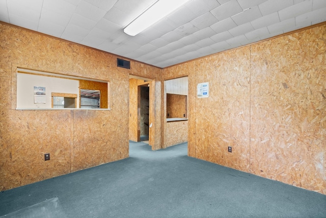 empty room featuring dark colored carpet