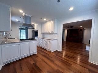 kitchen featuring sink, dark hardwood / wood-style floors, oven, extractor fan, and white cabinets