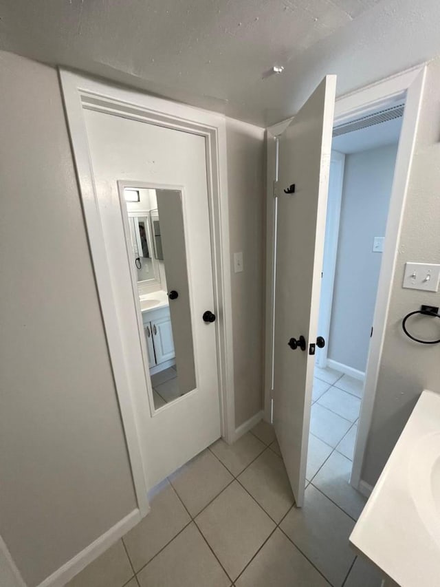 hallway featuring light tile patterned floors