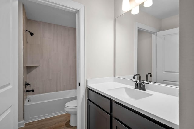 full bathroom featuring bathing tub / shower combination, vanity, wood-type flooring, and toilet