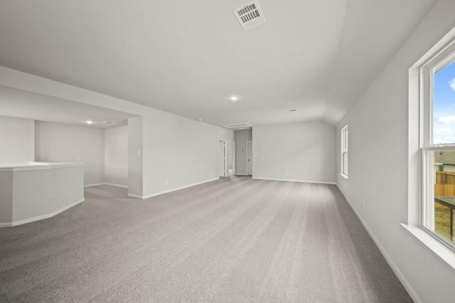 unfurnished room featuring carpet, visible vents, and baseboards