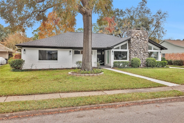 ranch-style home featuring a front yard