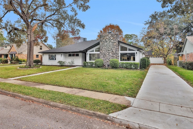 view of front of home with a garage and a front yard